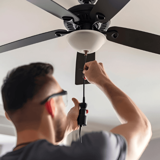 Man Installing a Ceiling Fan; electrical